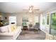 Inviting living area with a ceiling fan, access to the patio, and hardwood style floors at 649 Tupelo Ln. # 13A, Longs, SC 29568