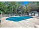 Large community pool with sun loungers, white fencing and lush tree perimeter at 649 Tupelo Ln. # 13A, Longs, SC 29568