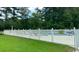 Community pool with a white fence, sun loungers and beautiful lush landscaping at 649 Tupelo Ln. # 13A, Longs, SC 29568