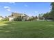 Large backyard with green lawn, mature trees, and a home featuring a deck, porch, and shed at 812 Buteo Ct., Myrtle Beach, SC 29588