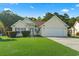 Charming single-story home features a well-manicured lawn, attached garage, and inviting curb appeal at 812 Buteo Ct., Myrtle Beach, SC 29588