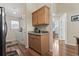 Kitchenette and hallway leads to a laundry room, with wooden cabinets and countertop space at 812 Buteo Ct., Myrtle Beach, SC 29588