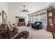 Spacious living room with plush seating, a ceiling fan, and lots of natural light at 812 Buteo Ct., Myrtle Beach, SC 29588
