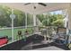Relaxing screened porch with a ceiling fan, views of the lush backyard, and comfortable seating area at 812 Buteo Ct., Myrtle Beach, SC 29588
