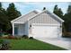Charming single-Gathering home with a two-car garage, manicured lawn, and welcoming curb appeal at 867 Cypress Preserve Circle, Longs, SC 29568