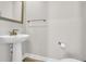 Simple half bath with a pedestal sink, brushed gold hardware, and clean lines at 9012 Mabel Ct., Longs, SC 29568
