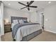 Comfortable bedroom boasts a gray upholstered headboard, ceiling fan, and under-bed storage drawers at 9012 Mabel Ct., Longs, SC 29568