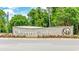 Ocean Club community entrance sign with flowers and green trees at 9012 Mabel Ct., Longs, SC 29568