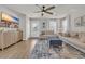Bright living room with wood floors, neutral palette, featuring a large TV and comfortable seating at 9012 Mabel Ct., Longs, SC 29568