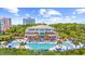 Exterior of the ocean front club with a swimming pool surrounded by palm trees, lounge chairs and seating at 9012 Mabel Ct., Longs, SC 29568