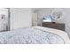 Cozy bedroom featuring light blue walls, large closet, a mounted television, and a quaint round mirror at 9501 Shore Dr. # B-316, Myrtle Beach, SC 29572