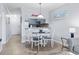 The dining area features a table with seating for four and a view of the modern kitchen at 9501 Shore Dr. # B-316, Myrtle Beach, SC 29572