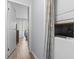 Hallway view showing the laundry closet and the entrance to the bedroom and ensuite balcony beyond at 9501 Shore Dr. # B-316, Myrtle Beach, SC 29572
