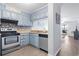 Updated kitchen featuring stainless steel appliances, attractive backsplash, and blue cabinetry at 9501 Shore Dr. # B-316, Myrtle Beach, SC 29572
