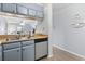 Galley kitchen view of sink with stainless steel dishwasher and wood counters at 9501 Shore Dr. # B-316, Myrtle Beach, SC 29572