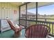 Relaxing screened-in patio with cushioned chairs and a glimpse of the surrounding neighborhood at 9501 Shore Dr. # B-316, Myrtle Beach, SC 29572
