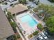 Aerial view of the community pool with lounge chairs and tables, surrounded by mature trees at 9501 Shore Dr. # B-316, Myrtle Beach, SC 29572