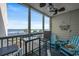 Relaxing screened-in porch with comfortable seating, a ceiling fan, and stunning ocean views at 9570 Shore Dr. # 204, Myrtle Beach, SC 29572
