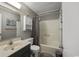 Neutral-toned bathroom with a tub and shower, a storage cabinet, and essential amenities at 9570 Shore Dr. # 204, Myrtle Beach, SC 29572