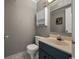 Cozy half bath featuring a wall cabinet, toilet, and sink with a unique faucet at 9570 Shore Dr. # 204, Myrtle Beach, SC 29572