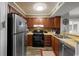 Functional kitchen featuring wooden cabinets, essential appliances, and ample counter space for meal preparation at 9570 Shore Dr. # 204, Myrtle Beach, SC 29572
