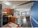 Cozy kitchen featuring wooden cabinetry, stainless steel appliances, and a breakfast bar open to the living area at 9570 Shore Dr. # 204, Myrtle Beach, SC 29572