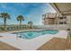 Inviting outdoor pool area surrounded by lounge chairs and palm trees at 9570 Shore Dr. # 204, Myrtle Beach, SC 29572