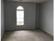 Bedroom featuring neutral paint, carpeted floor, and a single window with an arched top providing natural light at 9739 Leyland Dr. # 12, Myrtle Beach, SC 29572