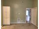 Neutral bedroom features built-in storage, thermostat, HVAC vent, and a glimpse into the well-lit bathroom at 9739 Leyland Dr. # 12, Myrtle Beach, SC 29572