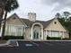 Welcoming tan clubhouse features a unique tower, arched entry, ample parking, and convenient accessibility ramps at 9739 Leyland Dr. # 12, Myrtle Beach, SC 29572