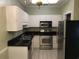 Bright kitchen with stainless steel appliances, black countertop, and white cabinets at 9739 Leyland Dr. # 12, Myrtle Beach, SC 29572