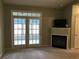Living room with a fireplace, and french doors leading to the outside at 9739 Leyland Dr. # 12, Myrtle Beach, SC 29572