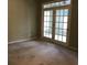 Living room showcasing neutral walls, carpeted flooring, and glass french doors, creating an inviting space at 9739 Leyland Dr. # 12, Myrtle Beach, SC 29572