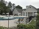 Community swimming pool with fountain, sun loungers, umbrellas, fenced enclosure and easy clubhouse access at 9739 Leyland Dr. # 12, Myrtle Beach, SC 29572