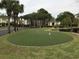 Enjoy the putting green nestled among palm trees and manicured landscaping at this home in a golf community at 9739 Leyland Dr. # 12, Myrtle Beach, SC 29572