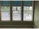 Bright room with three windows featuring white trim and modern blinds looking out onto a landscaped exterior at 9739 Leyland Dr. # 12, Myrtle Beach, SC 29572