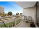 Balcony with seating overlooking street, beach, and ocean views, a perfect place to relax and enjoy the scenery at 9820 Queensway Blvd. # 105, Myrtle Beach, SC 29572