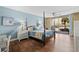 Bedroom with four-poster bed, light blue walls, ceiling fan, wood floors, and sliding doors to a balcony at 9820 Queensway Blvd. # 105, Myrtle Beach, SC 29572