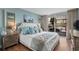 Charming bedroom featuring a plush bed, light blue walls and a sliding glass door to a balcony at 9820 Queensway Blvd. # 105, Myrtle Beach, SC 29572