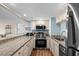 Galley kitchen with stainless steel appliances, granite countertops, and views through to the living area at 9820 Queensway Blvd. # 105, Myrtle Beach, SC 29572