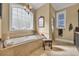 Bright bathroom featuring a soaking tub with tile surround, a vanity, and a separate shower at 107 Long Bay Golf Pl., Longs, SC 29568