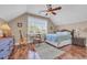 Inviting bedroom with a large window and hardwood floors, featuring a woven dresser and matching nightstand at 107 Long Bay Golf Pl., Longs, SC 29568