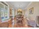 Formal dining room boasts hardwood floors, crown molding, and elegant chandelier at 107 Long Bay Golf Pl., Longs, SC 29568