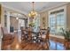 Bright dining room features a chandelier, hardwood floors, and large windows at 107 Long Bay Golf Pl., Longs, SC 29568