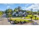 Charming traditional home featuring a circular driveway, lush green lawn, and mature trees at 107 Long Bay Golf Pl., Longs, SC 29568
