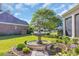Close up picture of a tiered water fountain surrounded by flowers and green landscaping at 107 Long Bay Golf Pl., Longs, SC 29568