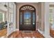 Welcoming foyer features a dark wood door, hardwood floors, and a view into the living space at 107 Long Bay Golf Pl., Longs, SC 29568
