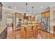 Spacious kitchen with an island, pendant lighting, and stainless steel appliances at 107 Long Bay Golf Pl., Longs, SC 29568