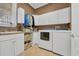 The laundry room features a sink, washer, dryer, storage cabinets, and space for folding at 107 Long Bay Golf Pl., Longs, SC 29568