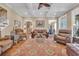 Open-concept living room with coffered ceilings, hardwood floors, and comfortable seating at 107 Long Bay Golf Pl., Longs, SC 29568